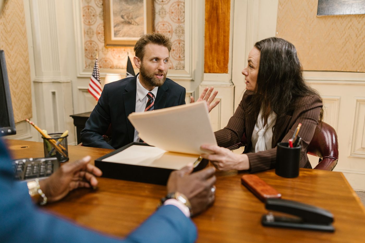 Clients in a legal consultation with documents on the table